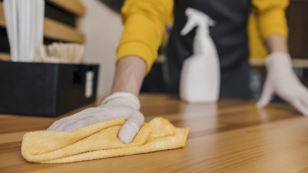 front-view-barista-cleaning-table